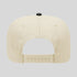 Beige cap with a black button on a light gray background